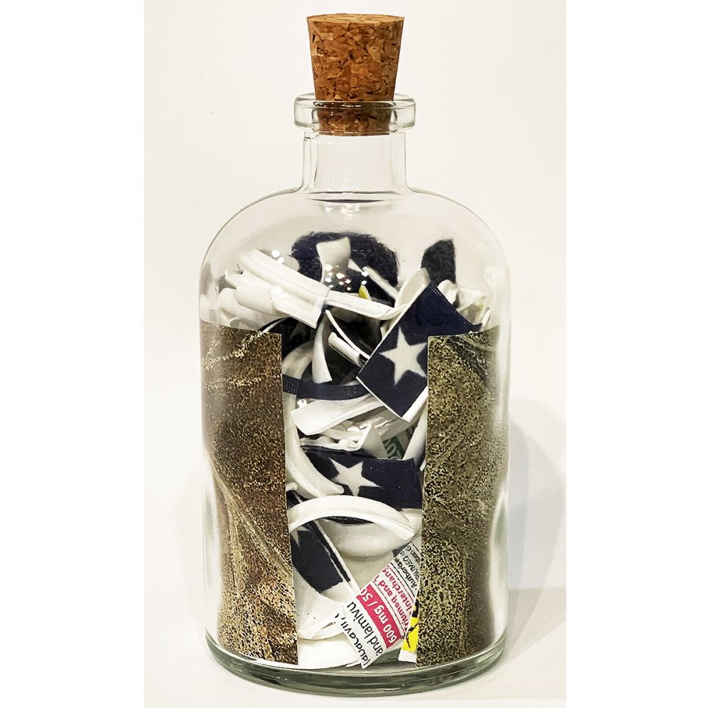 <br/>Caboc Praetorian back, 10/9/2025<br/>Apx 6½" x 3" x 3"<br/>glass, paper, ink, cork, plastic and cloth